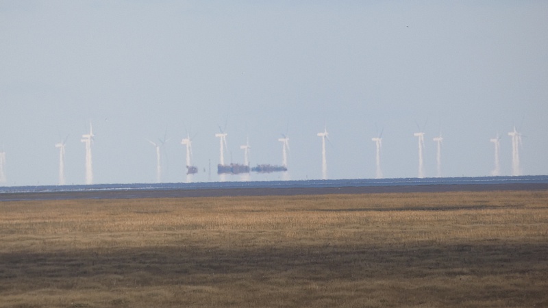 Select this image to see a larger version. The Lincs wind farm off Skegness from Butterwick Low. ~20 miles away.
